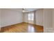 Bedroom featuring hardwood flooring, bright windows, and neutral paint at 110 Balsam Dr, Lincolnton, NC 28092