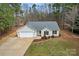 Inviting one-story home featuring lush landscaping, a gray roof, and an attached two-car garage at 113 Misty Spring Rd, Troutman, NC 28166