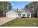 Lovely one-story home with well-kept lawn, gray siding, and attached two-car garage at 113 Misty Spring Rd, Troutman, NC 28166