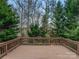 Open wooden deck overlooking a peaceful, wooded backyard setting with mature trees and fresh air at 114 Sheridan Ct, Mooresville, NC 28115