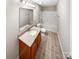 Well-lit bathroom with a single sink vanity, a large mirror, tile floors, and a shower-tub combination at 114 Sheridan Ct, Mooresville, NC 28115