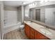 Bathroom with double sink vanity, large mirror, tile floors, and shower over tub combo at 114 Sheridan Ct, Mooresville, NC 28115