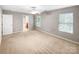 Spacious bedroom with neutral carpet, two large windows, and ensuite access at 114 Sheridan Ct, Mooresville, NC 28115