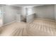 Spacious hallway with plush carpeting, neutral walls, and stairs leading to the upper level at 114 Sheridan Ct, Mooresville, NC 28115