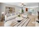 Bright, staged living room featuring a comfortable sofa, stylish decor and open concept at 114 Sheridan Ct, Mooresville, NC 28115