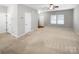 Open living room featuring carpet, neutral paint, and many windows. Ready for your personal touch at 114 Sheridan Ct, Mooresville, NC 28115