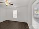 Bright bedroom features wood-look flooring, ceiling fan, and natural light from the double-paned windows at 1141 6Th St, Lancaster, SC 29720