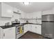 Well-lit kitchen with white cabinetry, black countertops, and stainless steel appliances at 1141 6Th St, Lancaster, SC 29720