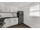 Efficient kitchen with white cabinets, dark countertops, and stainless steel appliances at 1141 6Th St, Lancaster, SC 29720