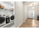 Hallway view showing the laundry room, light fixtures, and an entryway at 13012 Canterbury Castle Dr, Charlotte, NC 28273