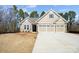 Newly constructed home with stone detailing, a three-car garage, and a well-manicured lawn at 13101 Cozy Ct, Charlotte, NC 28215