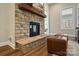 Close up of the living rooms stone fireplace with wood mantel and stone hearth at 13101 Cozy Ct, Charlotte, NC 28215