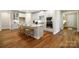 New kitchen boasts a center island with barstool seating and stainless steel appliances at 13101 Cozy Ct, Charlotte, NC 28215