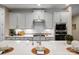Modern kitchen with stainless steel appliances, white countertops, and gray subway tile backsplash at 13101 Cozy Ct, Charlotte, NC 28215