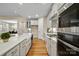 Bright kitchen features white cabinets, stainless steel appliances and a farmhouse sink at 13101 Cozy Ct, Charlotte, NC 28215
