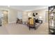 Bright living room with neutral carpet, stylish seating, and a decorative accent wall at 13101 Cozy Ct, Charlotte, NC 28215