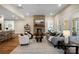 Inviting living room showcasing stone fireplace, plush seating, and hardwood flooring at 13101 Cozy Ct, Charlotte, NC 28215