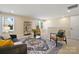 Spacious living room with large windows, comfortable seating, and modern decor at 13101 Cozy Ct, Charlotte, NC 28215