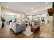 Expansive living room with open layout to kitchen, stone fireplace, and cozy seating area at 13101 Cozy Ct, Charlotte, NC 28215