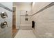 Walk-in shower features stylish tile, a built-in seat and niche, with glass surround and nice fixtures at 13101 Cozy Ct, Charlotte, NC 28215