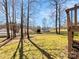 Large backyard with mature trees and wooden fence, offering a private and serene outdoor space at 1311 Shady Oak Trl, Gastonia, NC 28052