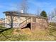 Backyard view with a wooden deck, offering a relaxing outdoor space for entertaining and enjoying nature at 1311 Shady Oak Trl, Gastonia, NC 28052