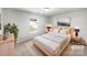 Cozy bedroom with a large window, a comfortable bed, and neutral decor in a staged home at 1311 Shady Oak Trl, Gastonia, NC 28052