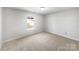 Bright bedroom with neutral carpet, white walls and natural light at 1311 Shady Oak Trl, Gastonia, NC 28052