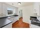 Functional kitchen features modern appliances, dual basin sink, black countertops, and ample white cabinetry at 1311 Shady Oak Trl, Gastonia, NC 28052
