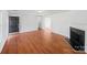 Spacious living room featuring hardwood floors, a fireplace, and a view into the dining room at 1311 Shady Oak Trl, Gastonia, NC 28052