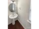 Half bath with pedestal sink, round mirror, and natural light at 133 Sequoia St, Mooresville, NC 28117