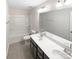 Bright bathroom with double vanity, tiled floors, and shower-tub combination at 133 Sequoia St, Mooresville, NC 28117