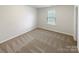 Comfortable bedroom with plush carpeting, a window for natural light, and a calming, minimalist style at 133 Sequoia St, Mooresville, NC 28117