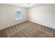 Inviting bedroom with soft carpet, natural light from the window, and soothing neutral tones at 133 Sequoia St, Mooresville, NC 28117