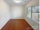 An empty bedroom with wood floors and a large window that lets in plenty of light at 133 Sequoia St, Mooresville, NC 28117