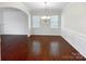 Formal dining room with wood floors, wainscoting, a modern light fixture, and natural light at 133 Sequoia St, Mooresville, NC 28117