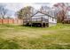 Vast backyard showcasing a wooden deck attached to the house and a tall wooden fence at 1331 14Th Ne St, Hickory, NC 28601