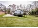 Expansive backyard featuring a lush green lawn, mature trees, and a wooden deck attached to the house at 1331 14Th Ne St, Hickory, NC 28601