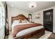 Cozy primary bedroom with a wood frame bed, decorative pillows, and natural light from a window at 1331 14Th Ne St, Hickory, NC 28601