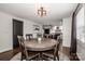 Bright dining room with a wooden table and chairs, and a view into the adjacent kitchen at 1331 14Th Ne St, Hickory, NC 28601