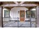 Charming covered front porch with rustic wood beams and black railing, perfect for relaxing outdoors at 1331 14Th Ne St, Hickory, NC 28601