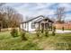 Well-maintained front yard with mature trees surrounding a charming home with a covered porch at 1331 14Th Ne St, Hickory, NC 28601