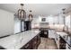 Open-concept kitchen with white cabinets, stainless steel appliances, marble countertops, and modern pendant lighting at 1331 14Th Ne St, Hickory, NC 28601