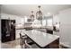 Well-lit kitchen with a center island, stainless steel appliances, and white cabinets with dark hardware at 1331 14Th Ne St, Hickory, NC 28601