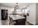 Modern kitchen with a large island, black hardware, white cabinets, and stainless steel appliances at 1331 14Th Ne St, Hickory, NC 28601