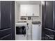 Convenient laundry room with white washer and dryer and overhead storage at 1331 14Th Ne St, Hickory, NC 28601
