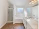 Sparkling clean bathroom features a tub, shower, and a double sink vanity at 13424 Kibworth Ln, Charlotte, NC 28273