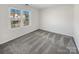 A sunlit bedroom with neutral carpet, a double window, and plenty of space at 13424 Kibworth Ln, Charlotte, NC 28273