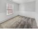 A simple bedroom featuring wall trim, neutral carpet, and a large double window at 13424 Kibworth Ln, Charlotte, NC 28273