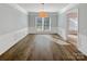 Bright dining room features hardwood floors, a modern light fixture, and large windows at 13424 Kibworth Ln, Charlotte, NC 28273